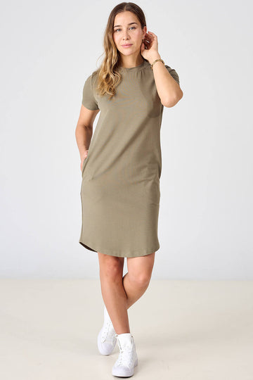 Woman wearing olive tencel t-shirt dress with side seam pockets by Advika. 