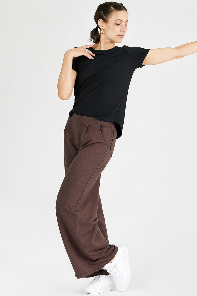 Woman wearing Tencel wide leg joggers in brown, Canadian made women's loungewear, standing