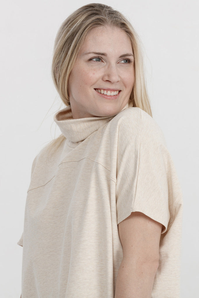 Woman wearing bamboo oversized turtleneck tunic in cream, Canadian made women's loungewear, shoulder close