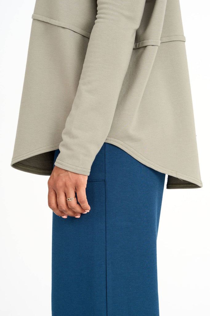Close-up of sleeve of eucalyptus green Tencel oversized Abigail turtleneck, made by Canadian loungewear label Advika. 