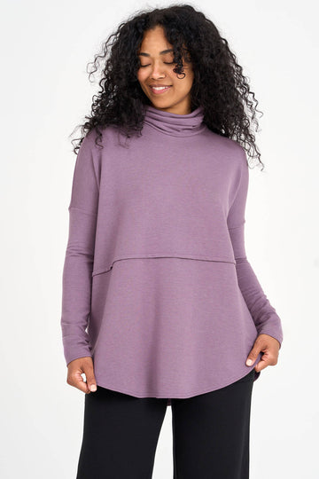 Woman wearing moonscape mauve Tencel oversized turtleneck, made by Canadian loungewear label Advika. 