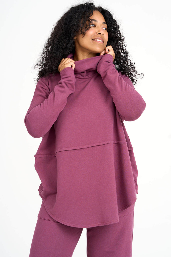 Woman wearing raspberry pink Tencel oversized Abigail turtleneck with matching palazzo pants, made by Canadian loungewear label Advika. 