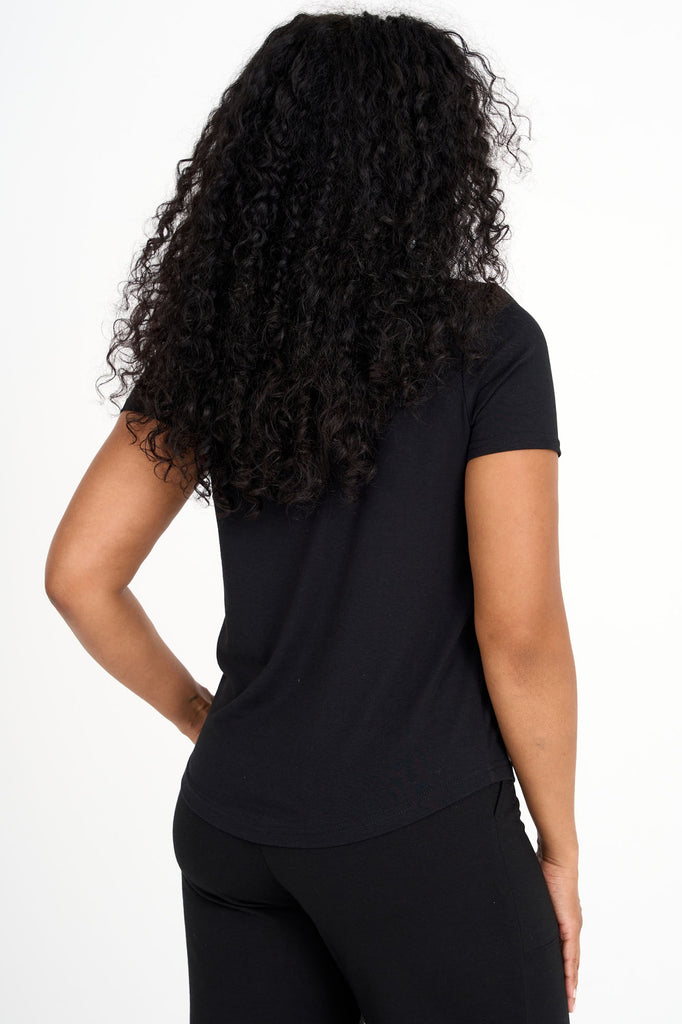 Back view of woman wearing black Tencel blend classic round neck t-shirt, made by Canadian loungewear label Advika.