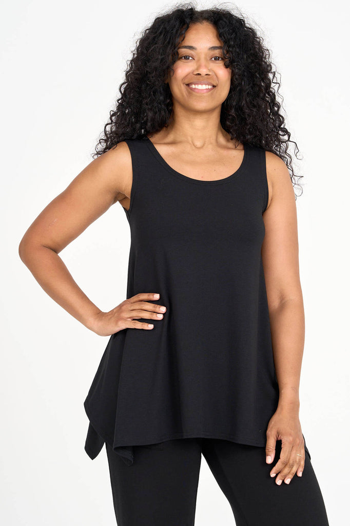 Woman wearing black Tencel flared tank top, made by Canadian loungewear label Advika. 