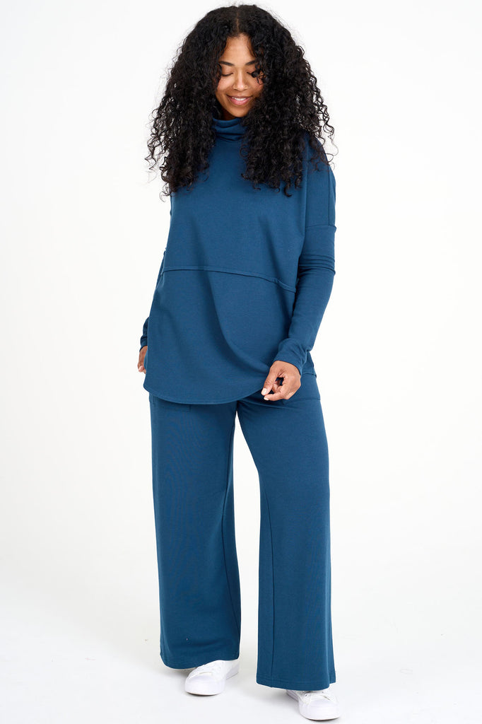 Woman wearing bluebell blue Abigail top with matching  blue tencel wide leg loungewear palazzo pants by Advika. 