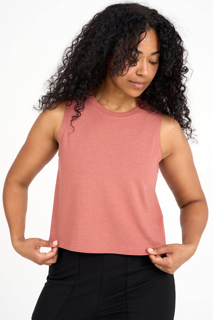 Woman wearing light brick pink tencel cropped tank top by Canadian loungewear label Advika. 
