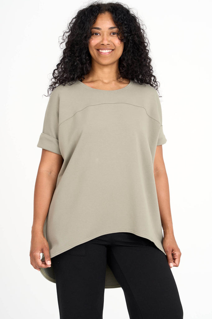 Woman wearing eucalyptus green Tencel short sleeve slouchy top with back pleat detail, made by Canadian loungewear label Advika. 