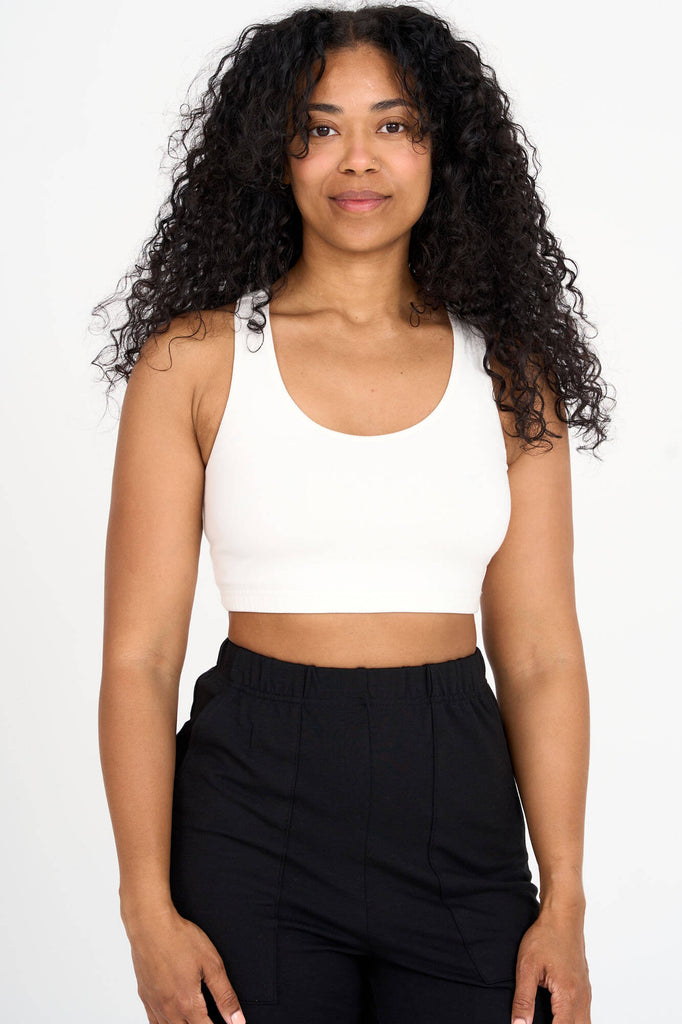 Woman wearing ivory white Tencel blend sports bra, made by Canadian loungewear label Advika.