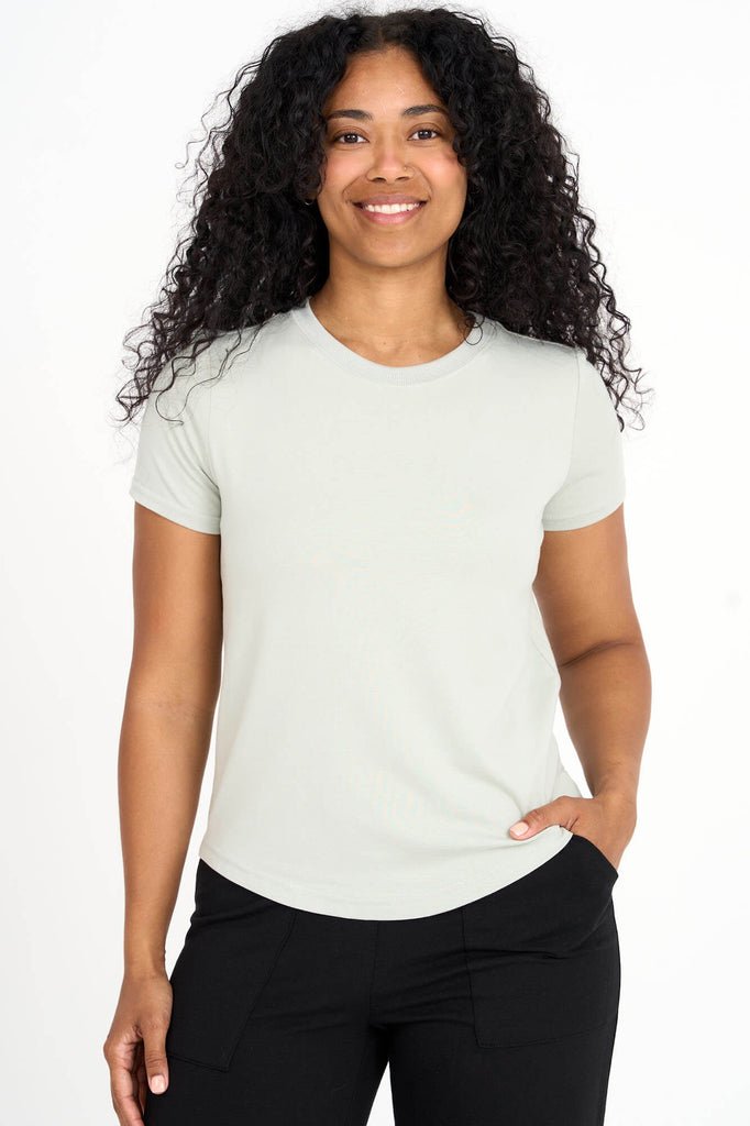 Woman wearing light sage green Tencel blend classic round neck t-shirt, made by Canadian loungewear label Advika.