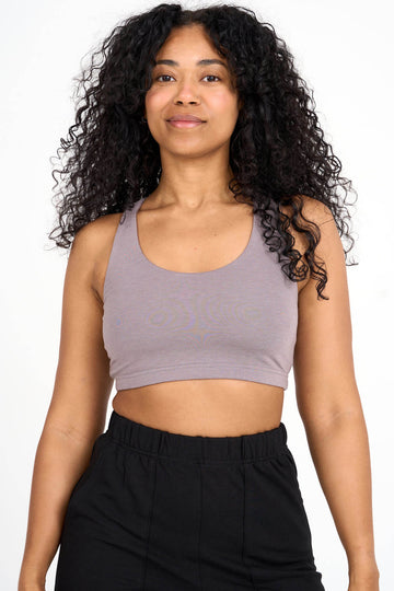 Woman wearing mink grey Tencel blend sports bra, made by Canadian loungewear label Advika.