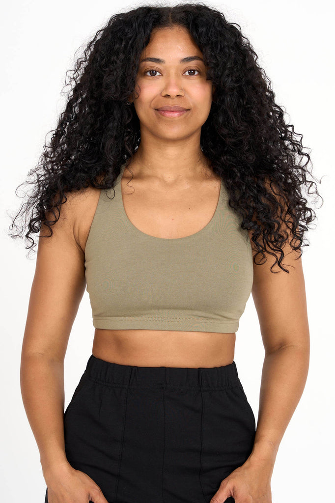 Woman wearing olive green Tencel blend sports bra, made by Canadian loungewear label Advika.