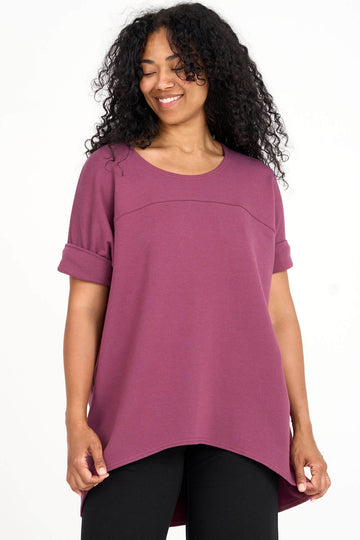 Woman wearing raspberry pink Tencel short sleeve slouchy top with back pleat detail, made by Canadian loungewear label Advika. 