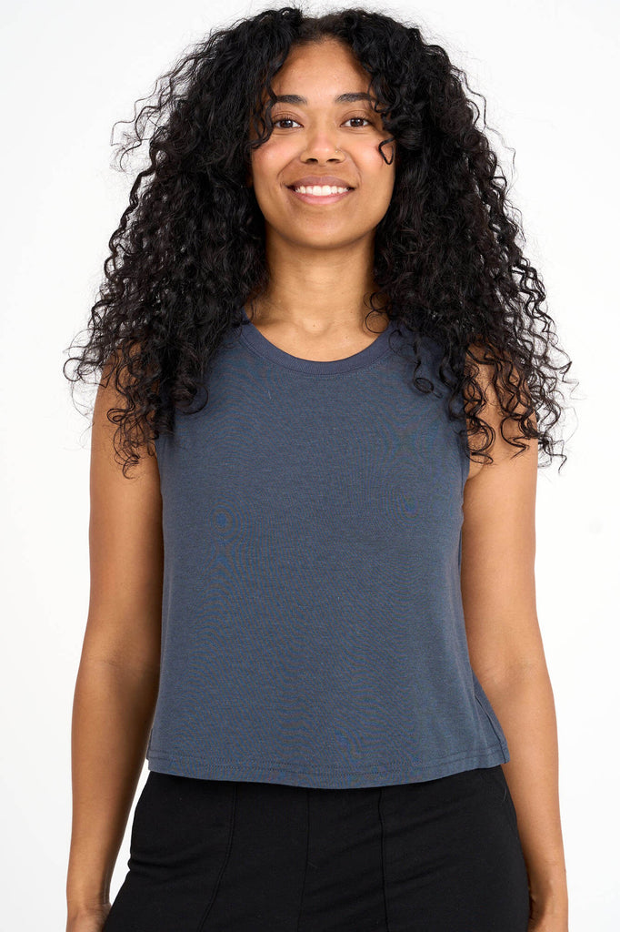 Woman wearing steel blue tencel cropped tank top by Canadian loungewear label Advika. 
