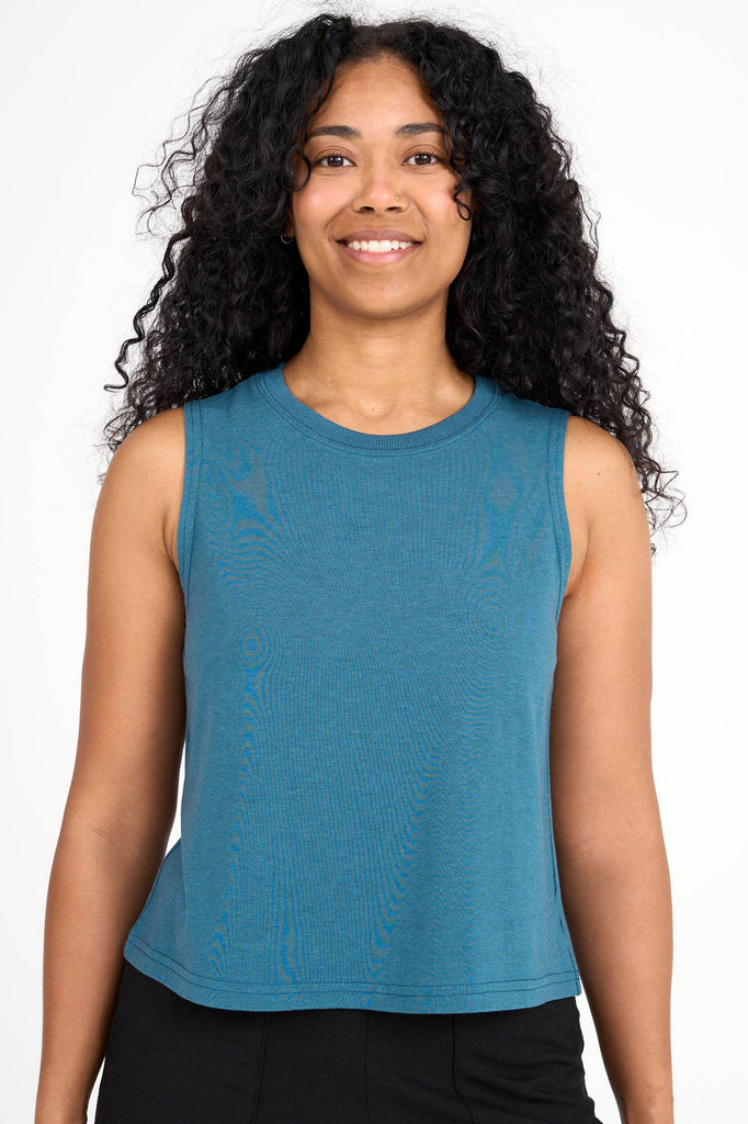 Woman wearing dusty teal tencel cropped tank top by Canadian loungewear label Advika. 