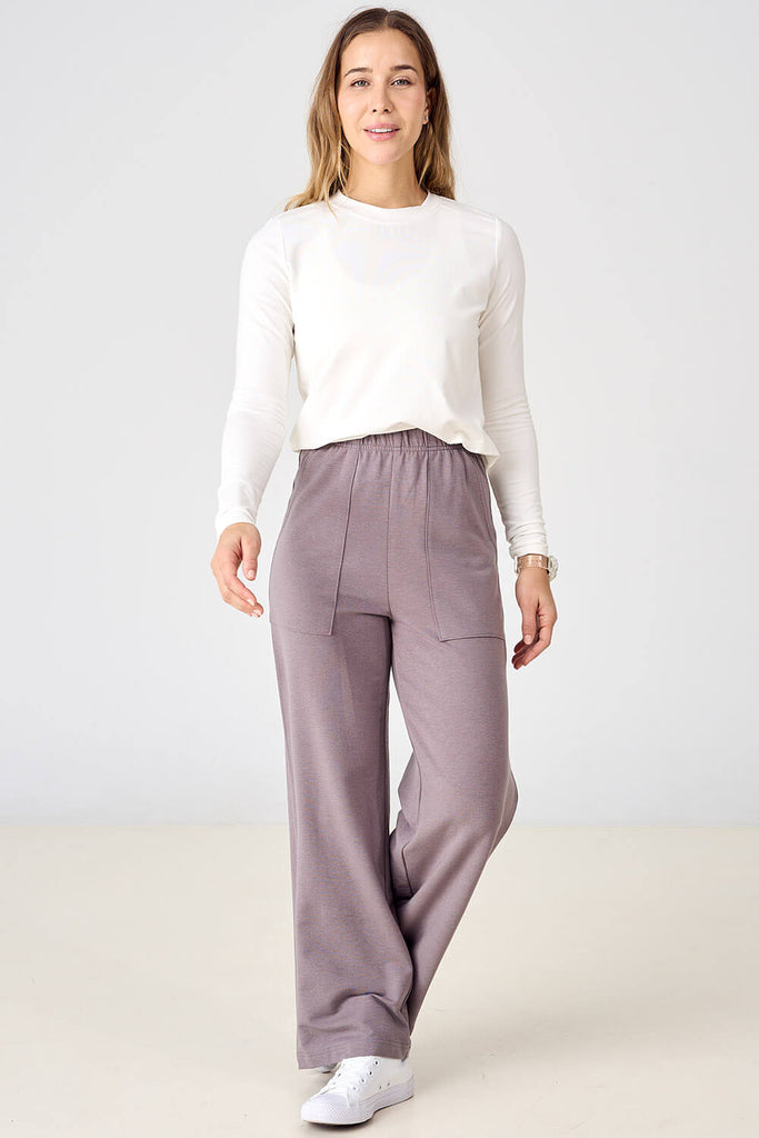 Woman wearing grey mauve tencel palazzo pants by Advika. 