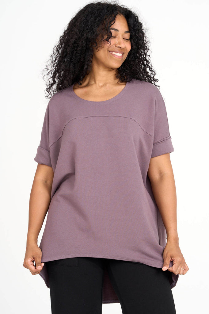 Woman wearing ube purple Tencel short sleeve slouchy top with back pleat detail, made by Canadian loungewear label Advika. 