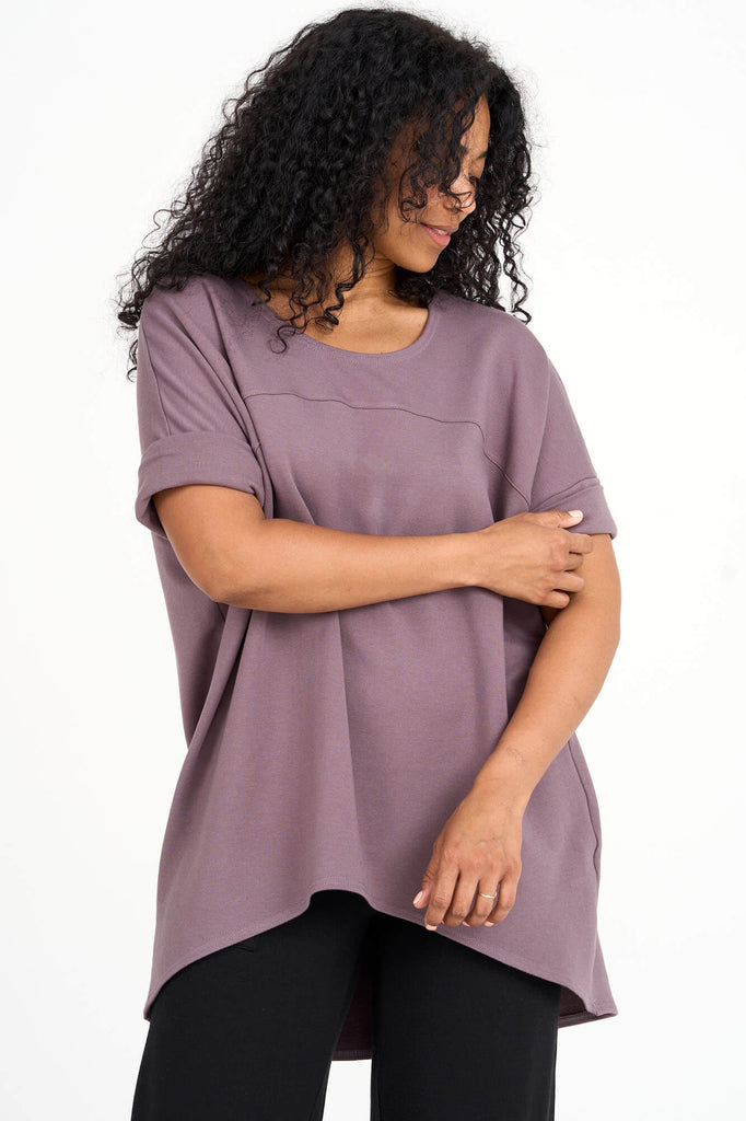 Woman wearing ube purple Tencel short sleeve slouchy top with back pleat detail, made by Canadian loungewear label Advika. 