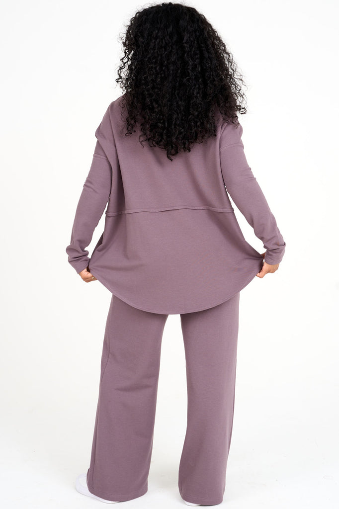 Back view of woman wearing ube purple Abigail top with matching  tencel wide leg loungewear palazzo pants by Advika. 