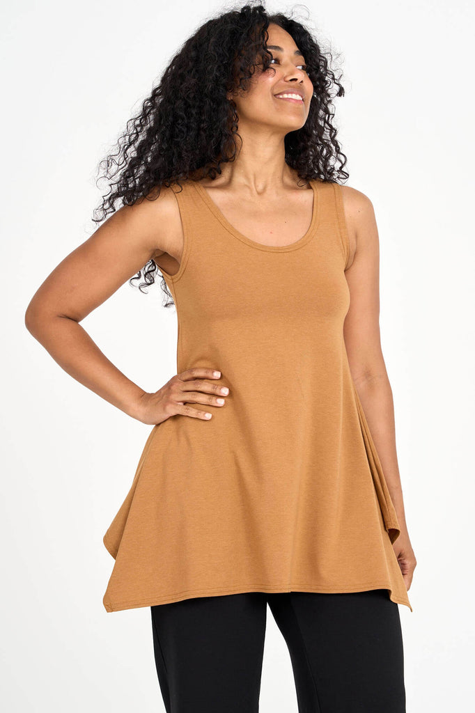 Woman wearing whiskey yellow Tencel flared tank top, made by Canadian loungewear label Advika. 