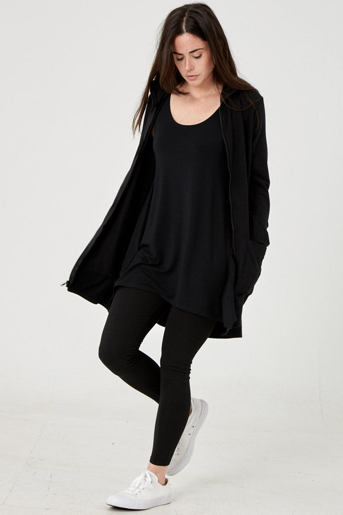 Woman wearing Tencel hoodie in black, Canadian made women's loungewear, standing