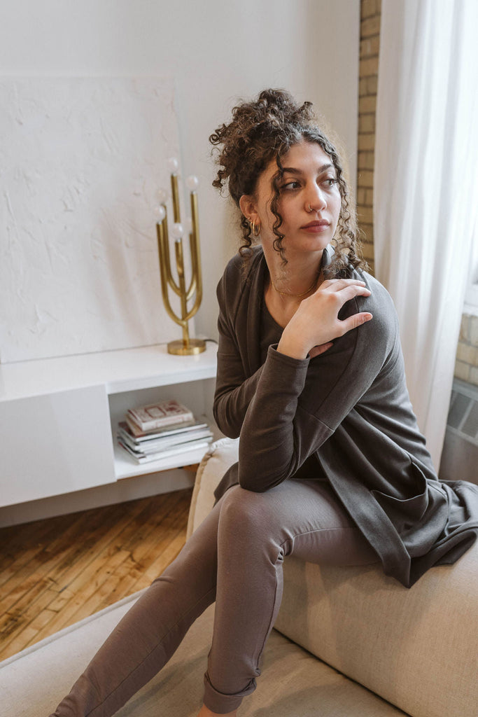 Woman wearing Tencel slim joggers in grey, Canadian made women's loungewear, sitting