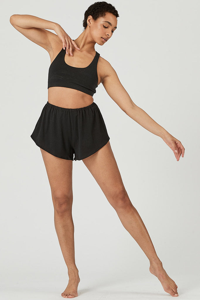 Woman wearing Tencel lounge shorts in black, Canadian made women's loungewear, standing