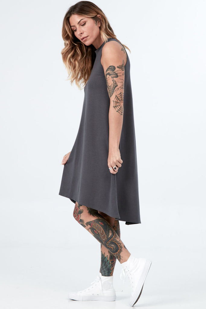 Woman wearing Tencel mock neck sleeveless dress, Canadian made women's loungewear, standing side