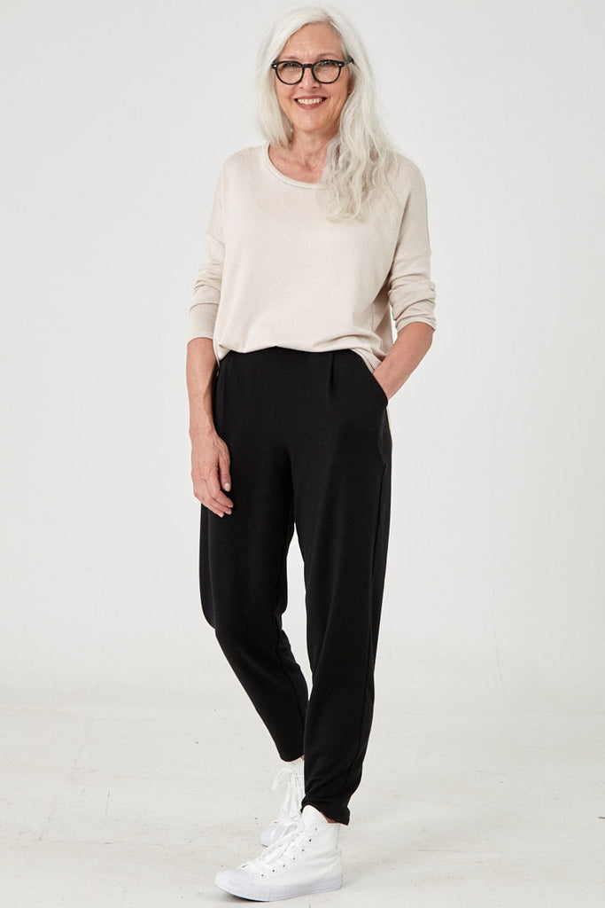 Woman wearing Tencel pleated pants in black, Canadian made women's loungewear, front