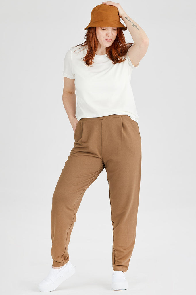 Woman wearing Tencel pleated pants in brown, Canadian made women's loungewear, front