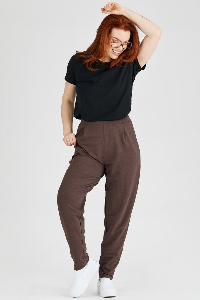 Woman wearing Tencel pleated pants in dark brown, Canadian made women's loungewear, front