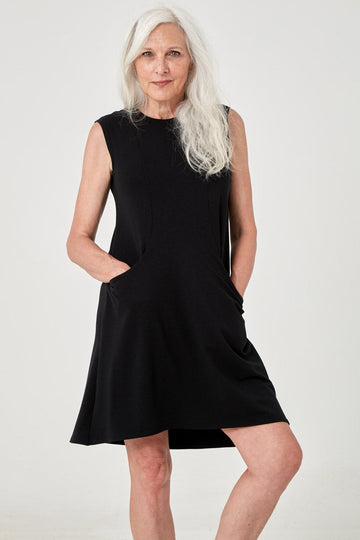 Woman wearing Tencel sleeveless tunic with pockets in black, Canadian made loungewear, standing