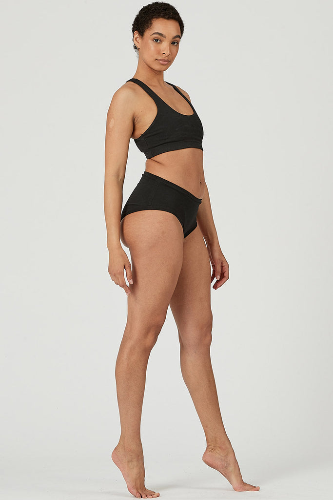 Woman wearing Tencel sports bra in black, Canadian made women's loungewear, side