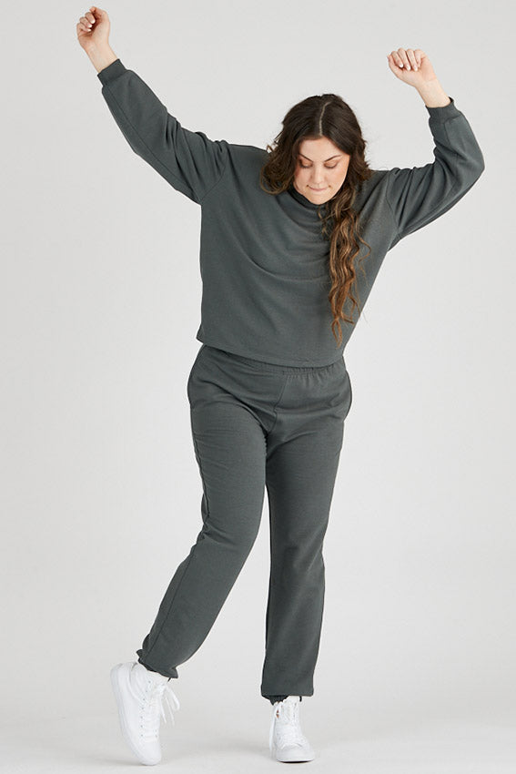 Woman wearing bamboo fleece sweatpants in dark grey, Canadian made women's loungewear, standing