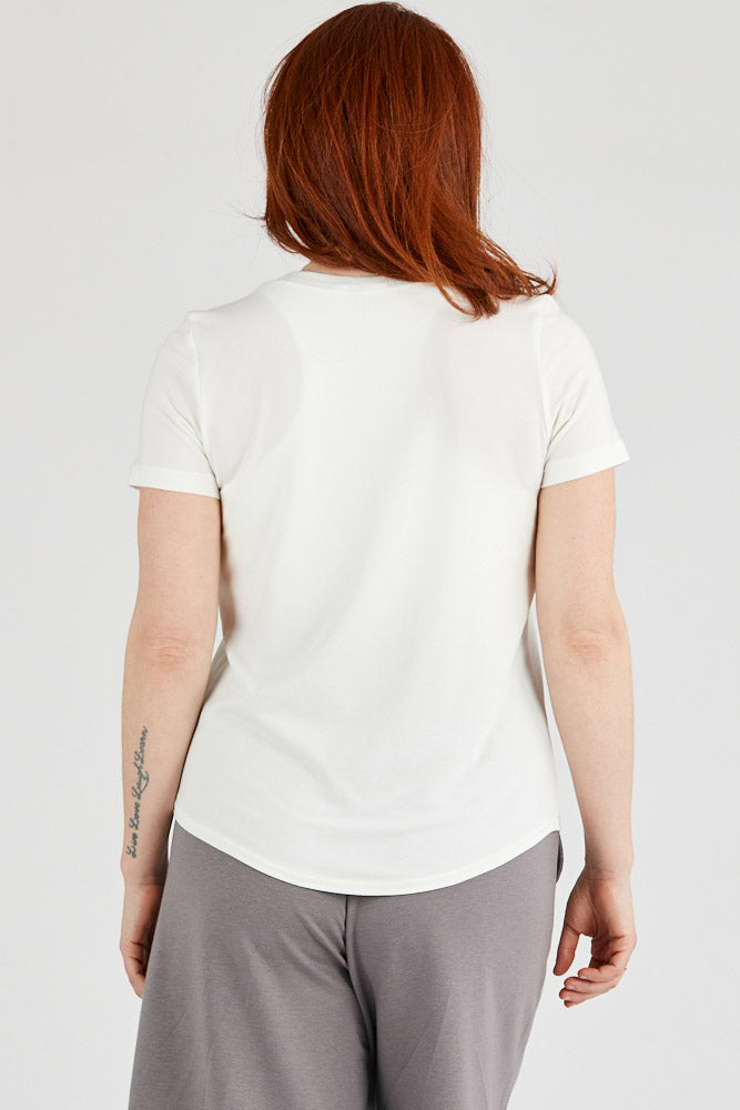 Woman wearing basic Tencel t-shirt in ivory, Canadian made women's loungewear, back