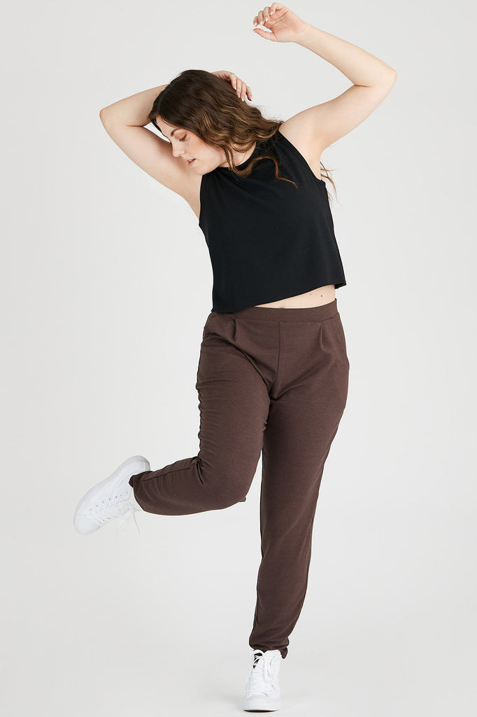 Woman wearing Tencel pleated pants in dark brown, Canadian made women's loungewear, leg up